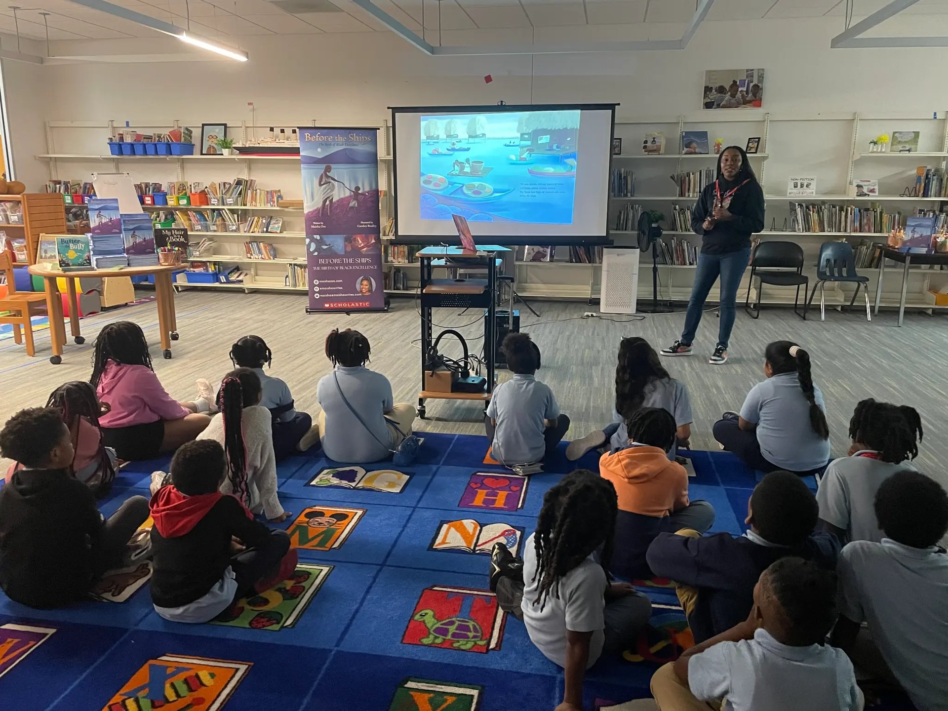 Maisha Oso presenting to a classroom